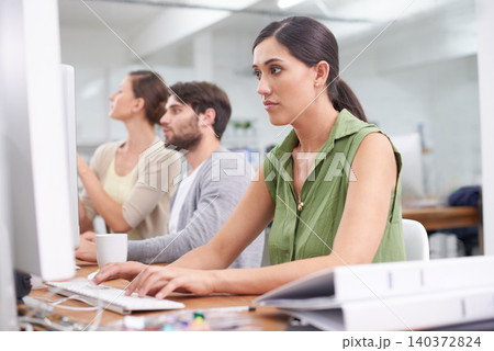 Computer, administration and email with business woman at desk in office to work on company report. Internet, planning or review with serious young employee typing feedback in professional workplace Computer, administration and email with business woman at desk in office to work on company report. Internet, planning or review with serious young employee typing feedback in professional workplace 140372824