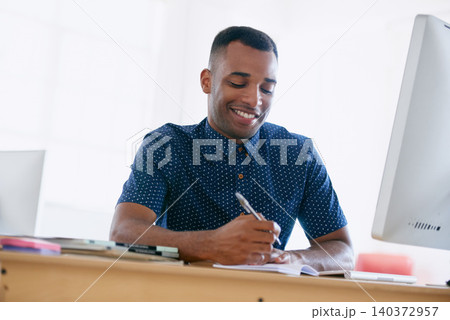 Computer, research and man writing notes in office for creative project on internet by desk. Technology, smile and professional male designer working online with desktop in modern workplace. 140372957