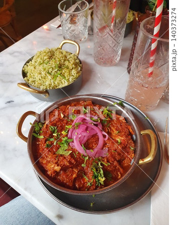 Spicy Pulled Chicken Curry With Pickled Red Onions, Herb Rice and Refreshing Drinks on Marble Table Spicy Pulled Chicken Curry With Pickled Red Onions, Herb Rice and Refreshing Drinks on Marble Table 140373274
