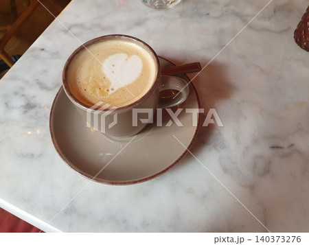 Latte Coffee With Heart Latte Art In Ceramic Cup On Marble Table At Cozy Cafe Latte Coffee With Heart Latte Art In Ceramic Cup On Marble Table At Cozy Cafe 140373276