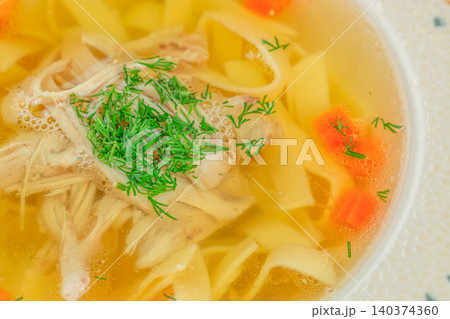 Homemade Chicken Noodle Soup Closeup with Fresh Dill and Vegetables Homemade Chicken Noodle Soup Closeup with Fresh Dill and Vegetables 140374360