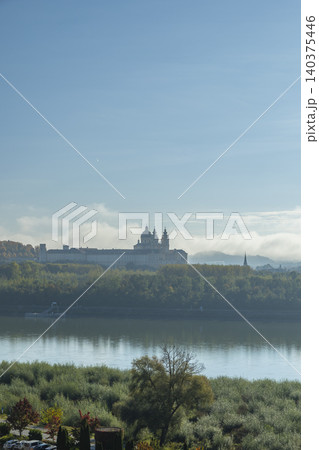 Melk Abbey rising above Danube River, morning mist Melk Abbey rising above Danube River, morning mist 140375446
