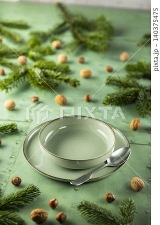 Festive table setting with fir branches and nuts Festive table setting with fir branches and nuts 140375475