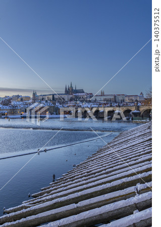 Prague Castle and Charles Bridge in winter snowing 140375512