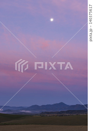 Full moon rising over mountains at twilight 140375617