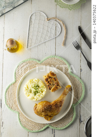 Roasted chicken leg dinner with savory bread pudding Roasted chicken leg dinner with savory bread pudding 140375622