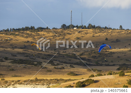 Paragliders flying over dry landscape in Creissels Paragliders flying over dry landscape in Creissels 140375661