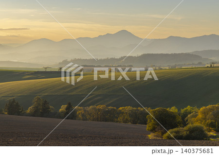 Rural fields and rolling mountains at sunrise in Slovakia Rural fields and rolling mountains at sunrise in Slovakia 140375681