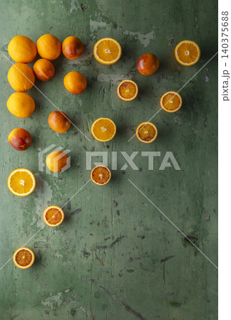 Fresh oranges and blood oranges on rustic green wood 140375688