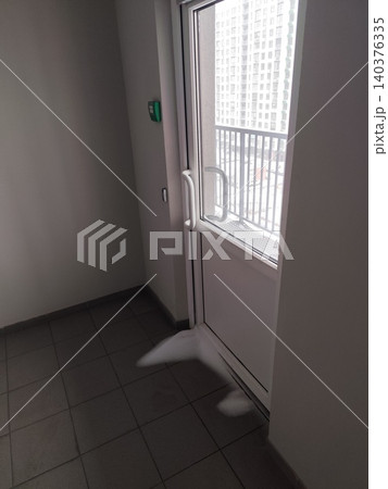Snow Drifting inside Apartment Building Balcony Door on Tiled Floor during Winter Blizzard Snow Drifting inside Apartment Building Balcony Door on Tiled Floor during Winter Blizzard 140376335