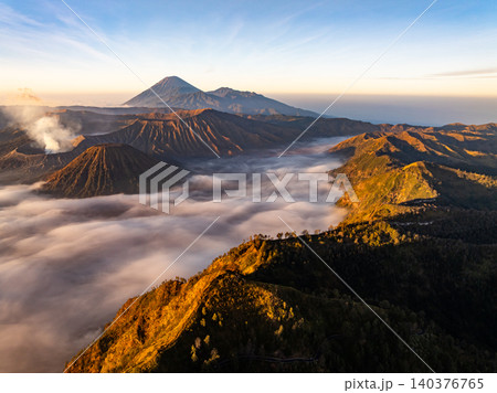 Amazing Mount Bromo volcano during sunrise from king kong viewpoint on Mountain Penanjakan in Bromo Tengger Semeru National Park,East Java,Indonesia.Nature landscape background Amazing Mount Bromo volcano during sunrise from king kong viewpoint on Mountain Penanjakan in Bromo Tengger Semeru National Park,East Java,Indonesia.Nature landscape background 140376765