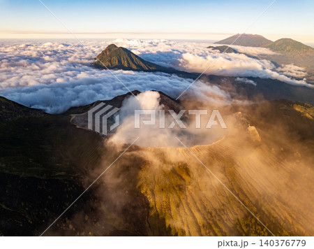Aerial view of rock cliff at Kawah Ijen volcano with turquoise sulfur water lake at sunrise.Amazing nature landscape view at East Java, Indonesia. Natural landscape background 140376779