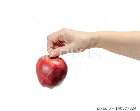 Woman's hand holding a red apple on the white background. Woman's hand holding a red apple on the white background. 140377824