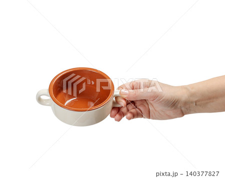 Woman's hand holding a cooking bowl on the white background. 140377827