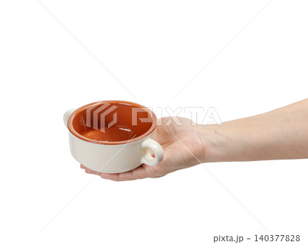 Cooking bowl on the woman's palm with the white background. Cooking bowl on the woman's palm with the white background. 140377828