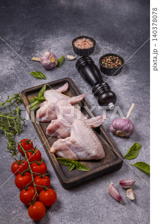 Raw chicken wings with fresh ingredients on grey background 140378078