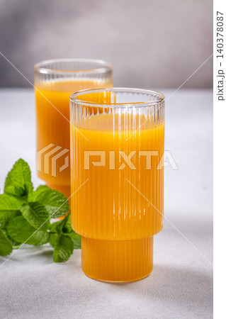 Refreshing orange juice with mint in glasses Refreshing orange juice with mint in glasses 140378087