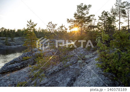 Nature skerry at Lake Ladoga against the background of the setting sun Nature skerry at Lake Ladoga against the background of the setting sun 140378189