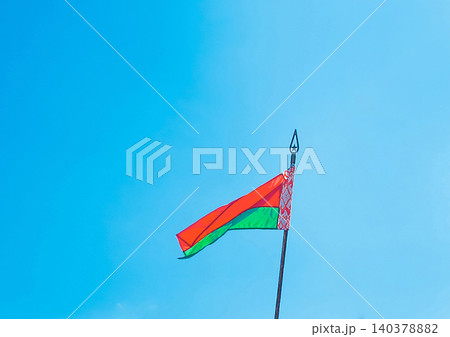 Belarusian national flag on a background of bright daytime blue sky 140378882