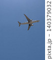 Wide Body Commercial Jet Aircraft Flying Overhead Against Clear Blue Sky 140379032