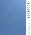 Commercial Twin Engine Jet Plane Overhead in Cloudless Blue Sky Upward View 140379034