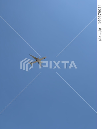 Commercial Twin Engine Jet Plane Overhead in Cloudless Blue Sky Upward View Commercial Twin Engine Jet Plane Overhead in Cloudless Blue Sky Upward View 140379034