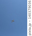 Commercial Airliner Flying Overhead in Clear Blue Sky With Lots of Open Space 140379036