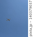 Small Airplane Silhouette Flying Against Vast Clear Blue Sky Minimal Photo 140379037