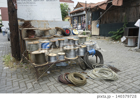 A display of various spools of wire and cable is set up outdoors on a paved area. A display of various spools of wire and cable is set up outdoors on a paved area. 140379728