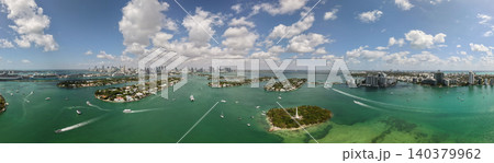 Panorama of Miami skyline and Biscayne Bay. Panoramic cityscape with coastal skyscrapers. Scenic view of Miami Beach from above. Drone captures Fisher Island and waterfront. Panorama of Miami skyline and Biscayne Bay. Panoramic cityscape with coastal skyscrapers. Scenic view of Miami Beach from above. Drone captures Fisher Island and waterfront. 140379962