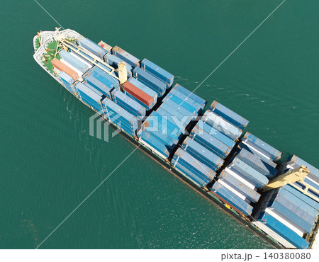 Container ship. Export and import. Cargo business. Shipping logistics. Cargo ship with container, aerial top view. Freight container on cargo vessel. Cargo ship vessel leaving port. Commercial vessel 140380080