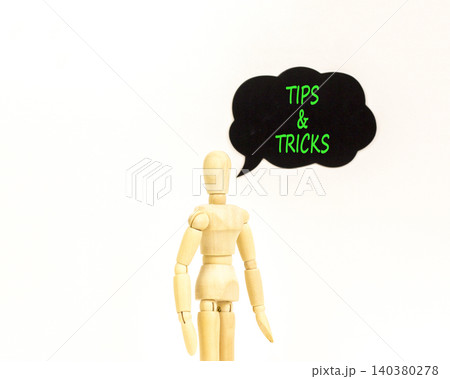 Tips and tricks symbol. Concept words Tips and tricks on beautiful black speech bubble. Beautiful white background. Businessman model. Business tips and tricks motivational support concept. Copy space Tips and tricks symbol. Concept words Tips and tricks on beautiful black speech bubble. Beautiful white background. Businessman model. Business tips and tricks motivational support concept. Copy space 140380278