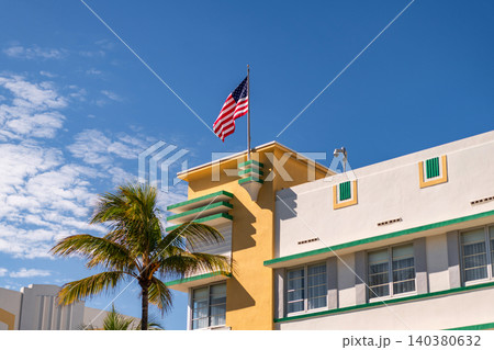 Ocean drive. Miami Beach in Ocean Drive Florida. Art Deco building architecture. Architectural building. Art deco. Architectural district Art Deco. Modern building of Miami beach with USA flag Ocean drive. Miami Beach in Ocean Drive Florida. Art Deco building architecture. Architectural building. Art deco. Architectural district Art Deco. Modern building of Miami beach with USA flag 140380632