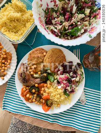 A filling, balanced breakfast with lentil and zucchini pancakes, millet, baked chicken neck, roasted sweet potatoes, broccoli, carrots, chickpeas, and a fresh salad with radish, sprouts, and nuts A filling, balanced breakfast with lentil and zucchini pancakes, millet, baked chicken neck, roasted sweet potatoes, broccoli, carrots, chickpeas, and a fresh salad with radish, sprouts, and nuts 140380836