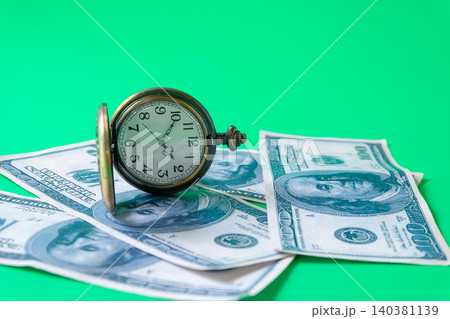 Vintage pocket o'clock over a bank note. Vintage pocket o'clock over a bank note. 140381139