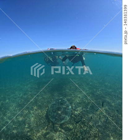A couple is snorkeling together on a coral reef in clear tropical waters A couple is snorkeling together on a coral reef in clear tropical waters 140381399