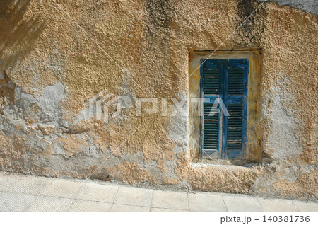 Old weathered blue window shutter in Athens 140381736