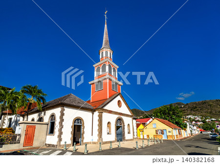 The colorful facade and steeple of the Saint Henri Catholic Church under a clear blue sky in the village of Les Anses d'Arlet, Martinique, Caribbean France The colorful facade and steeple of the Saint Henri Catholic Church under a clear blue sky in the village of Les Anses d'Arlet, Martinique, Caribbean France 140382168