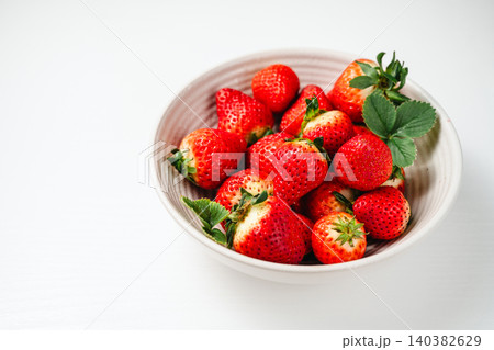 Strawberry red berry fruits in a bowl, isolated, abstract food background, top view with copy space Strawberry red berry fruits in a bowl, isolated, abstract food background, top view with copy space 140382629