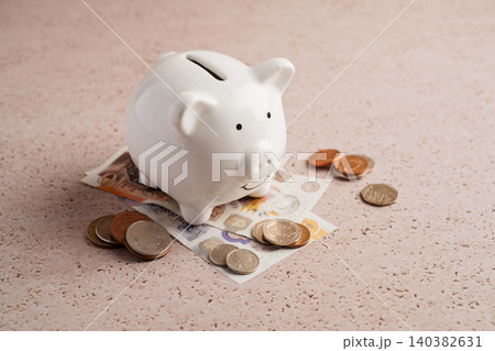 Piggy bank with coins and cash money, savings budgeting personal finance and financial security concept Piggy bank with coins and cash money, savings budgeting personal finance and financial security concept 140382631