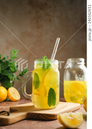 Iced lemonade with mint served in mason jar mug, rustic summer refreshment concept 140382651