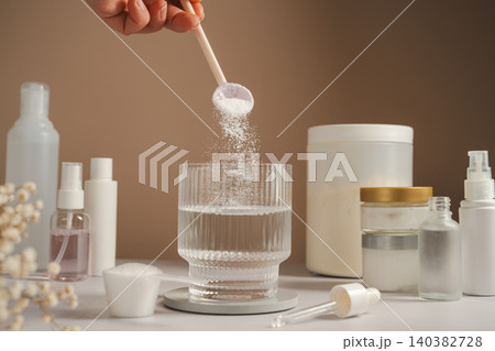 Collagen powder being added to water with skincare products and beauty wellness concept Collagen powder being added to water with skincare products and beauty wellness concept 140382728