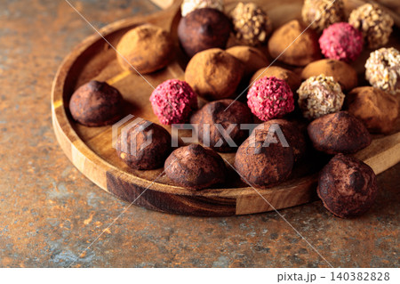 Chocolate truffles on a wooden tray. Chocolate truffles on a wooden tray. 140382828