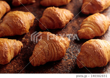 Croissants on a brown vintage background. Croissants on a brown vintage background. 140382831