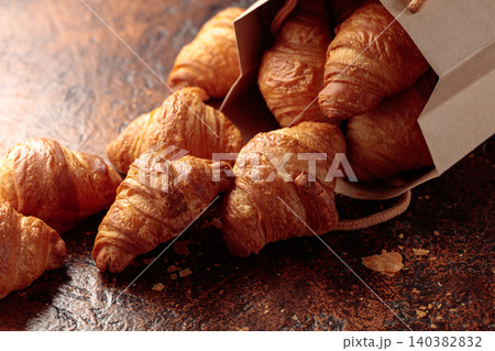 Fresh croissants on a brown vintage table. Fresh croissants on a brown vintage table. 140382832