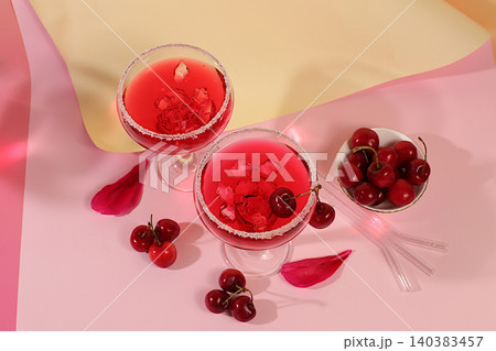 Modern still life with a summer alcoholic cocktail against a modern sunny background. Cherry punch on ice for a party. Minimalistic concept for a bar or cafe. Advertising banner or menu card. 140383457