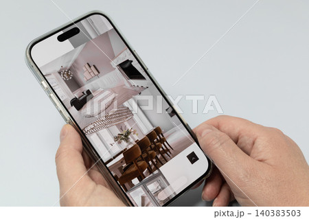 Browsing modern apartment interiors on smartphone screen Browsing modern apartment interiors on smartphone screen 140383503