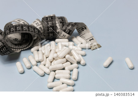 Weight loss capsules with measuring tape. Weight loss capsules with measuring tape. 140383514