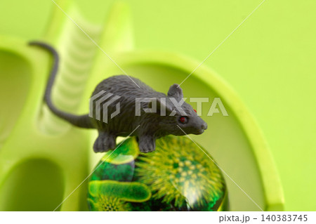 Mouse toy standing on abstract green orb Mouse toy standing on abstract green orb 140383745