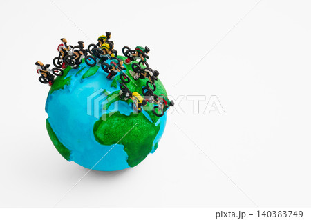 Cyclists racing global sustainability on miniature earth Cyclists racing global sustainability on miniature earth 140383749
